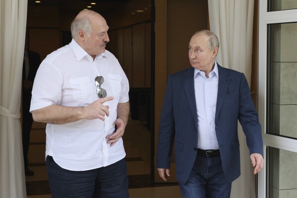 FILE - Russian President Vladimir Putin, right, and Belarusian President Alexander Lukashenko speak during their meeting at the Bocharov Ruchei residence in the resort city of Sochi, Russia, Friday, June 9, 2023. The Belarus Red Cross has sparked international outrage after its chief told Belarusian state television that the organization is actively involved in bringing Ukrainian children from Russian-occupied areas to Belarus. Both Ukraine and the Belarusian opposition have decried the transfer as unlawful deportations, and there have been calls for international war crimes charges for the authoritarian Belarus leader, similar to the charges against Russian President Vladimir Putin. (Gavriil Grigorov, Sputnik, Kremlin Pool Photo via AP, File)