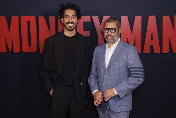 Dev Patel, left, and Jordan Peele pose for photographers upon arrival at the premiere of the film 'Monkey Man' in London on Monday, March 25, 2024. (Photo by Vianney Le Caer/Invision/AP)