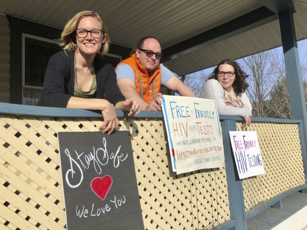 Solutions Oriented Addiction Response organizer Brooke Parker, left, and group co-founders Joe Solomon, center, and Sarah Stone, pose for a portrait Tuesday, March 9, 2021, in Charleston, W.Va. The nonprofit group operates health fairs for residents, including a syringe exchange and information about HIV testing. (AP Photo/John Raby)