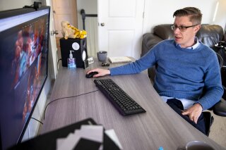 Mike Winkelmann, who goes by Beeple, shows off his digital art process in his home studio, Wednesday, Feb. 24, 2021, in Ladson, S.C. The $69.3 million March 11 online auction of a collage of 5,000 images by the artist by Christie’s auction house in London catapulted Beeple’s artwork into a league of the most expensive ever sold by a living artist. (Andrew J. Whitaker/The Post And Courier via AP)
