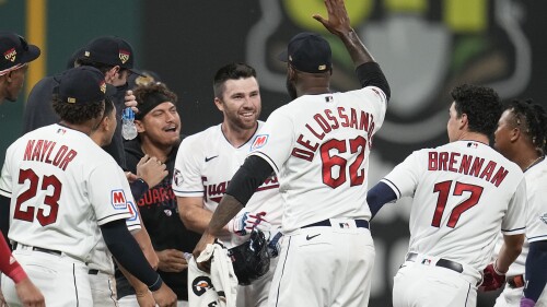 Cleveland Guardians' David Fry, center, is mobbed by teammates after hitting a game-winning single in the tenth inning of a baseball game against the Atlanta Braves, Tuesday, July 4, 2023, in Cleveland. (AP Photo/Sue Ogrocki)