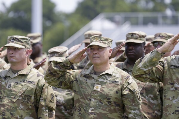 Maj. Michael Haley stands at attention during a deployment ceremony for his South Carolina National Guard unit on Saturday, June 17, 2023, in Charleston, S.C. Haley's yearlong deployment to Africa will encompass much of the campaign of his wife, former Gov. Nikki Haley, for the 2024 GOP presidential nomination. (AP Photo/Meg Kinnard)