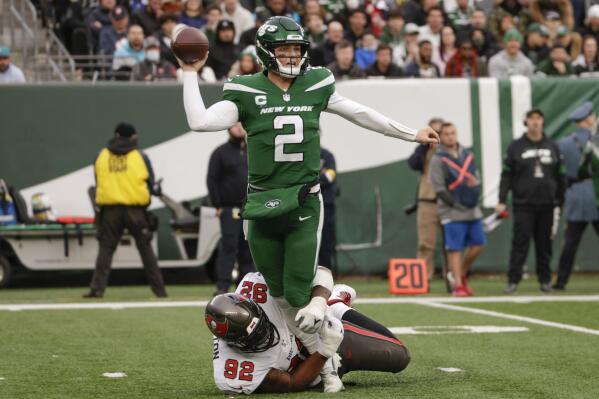 Tampa Bay Buccaneers' William Gholston, bottom, tackles New York Jets quarterback Zach Wilson as he throws the ball during the second half of an NFL football game, Sunday, Jan. 2, 2022, in East Rutherford, N.J. (AP Photo/Corey Sipkin)