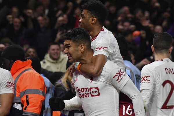 Manchester United's Casemiro celebrates with team mate Amad Diallo, top, after scoring his side's opening goal during the English FA Cup fifth round soccer match between Nottingham Forest and Manchester United at City ground in Nottingham, England, Wednesday, Feb. 28, 2024. (AP Photo/Rui Vieira)