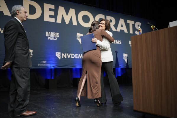 Sen. Jacky Rosen, D-Nev., hugs her daughter Miranda Rosen as her husband Larry Rosen, left, looks on during an election watch party Wednesday, Nov. 6, 2024, in Las Vegas. (AP Photo/John Locher)