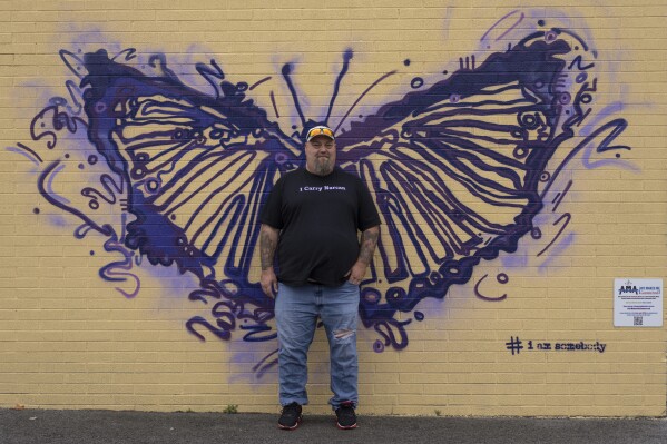 Cory Kinn, men's home coordinator and criminal justice liaison at FOCUS Recovery and Wellness Community, poses for a photograph at FOCUS in Findlay, Ohio, Friday, Oct. 20, 2023. Kinn, a former construction worker who got into recovery work after a stint in jail on a drug conviction, spends his nights as the live-in coordinator at the men's recovery house and his days working with clients involved in the criminal justice system. FOCUS offers free support and resources to anyone impacted by mental health, addiction, or trauma issues. (AP Photo/Carolyn Kaster)