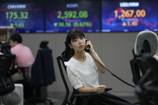 A currency trader talks on the phone at the foreign exchange dealing room of the KEB Hana Bank headquarters in Seoul, South Korea, Thursday, July 20, 2023. Asian shares were mixed Thursday after Japan reported weaker than expected trade data for June, with imports falling nearly 13% from a year earlier. (AP Photo/Ahn Young-joon)