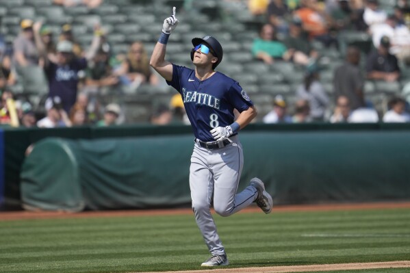 Seattle Mariners' Dominic Canzone (8) celebrates after hitting a two-run home run against the Oakland Athletics during the second inning of a baseball game in Oakland, Calif., Wednesday, Sept. 20, 2023. (AP Photo/Jeff Chiu)