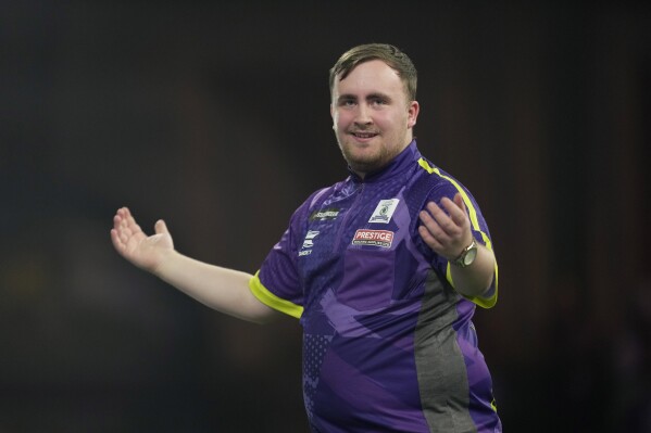 Luke Littler of England reacts during the semifinal match against Scott Williams of England at the World Darts Championship, in London, Tuesday, Jan. 2, 2024. (AP Photo/Kin Cheung)