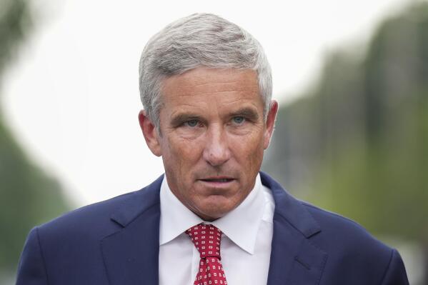 PGA Tour Commissioner Jay Monahan leaves after speaking with sports commentator Jim Nantz regarding the LIV Golf tour during fourth round of the Canadian Open at St. George's Golf and Country Club in Toronto, Sunday, June 12, 2022. (Nathan Denette/The Canadian Press via AP)