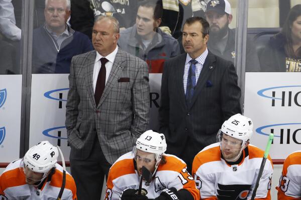 FILE - Philadelphia Flyers assistant Michel Therrien, left, and head coach Alain Vigneault stand behind their bench during the first period of an NHL hockey game against the Pittsburgh Penguins in Pittsburgh,  Oct. 29, 2019. The Philadelphia Flyers have fired coach Alain Vigneault following eight straight losses, two shy of matching a team record of 10 in a row, a person with knowledge of the situation told The Associated Press on Monday, Dec.  6, 2021. (AP Photo/Gene J. Puskar, File)