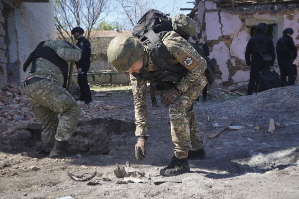 FILE - A police officer examines fragments of a guided bomb after the Russian air raid in Kharkiv, Ukraine, Tuesday, April 30, 2024. Russia pounded a town in Ukraine’s northeast with artillery, rockets and guided aerial bombs Friday May 10, 2024 before attempting an infantry breach of local defenses, authorities said, in a tactical switch that Kyiv officials have been expecting for weeks as the war stretches into its third year. (Ǻ Photo/Andrii Marienko, File)