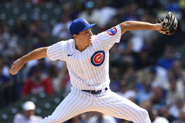 Colorado Rockies relief pitcher Daniel Bard left fielder Connor Joe (9) and  catcher Elias Diaz at the end of a baseball game against the Chicago Cubs  in Chicago, Sunday, Sept. 18, 2022. (