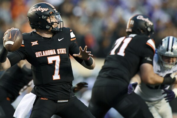 Oklahoma State quarterback Alan Bowman (7) looks for a receiver during the first half of the team's NCAA college football game against Kansas State on Friday, Oct. 6, 2023, in Stillwater, Okla. (AP Photo/Brody Schmidt)