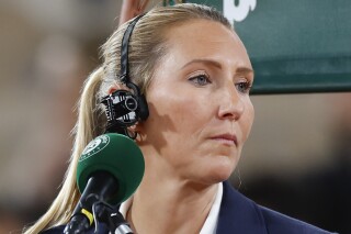 Chair umpire Aurelie Tourte of France wears a small TV camera during the second round match of the French Open tennis tournament between Japan's Naomi Osaka and Poland's Iga Swiatek at the Roland Garros stadium in Paris, Wednesday, May 29, 2024. (AP Photo/Jean-Francois Badias)