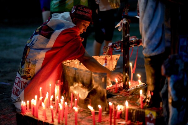 Juan Morel lights a candle at the sanctuary of Argentina's folk Saint 
