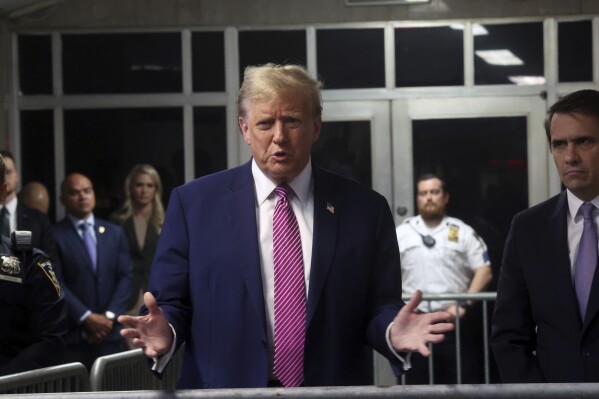 Former President Donald Trump speaks with the media following proceedings in his trial, Friday, April 19, 2024, at Manhattan Criminal Court in New York.  (Spencer Platt/Pool Photo via AP)