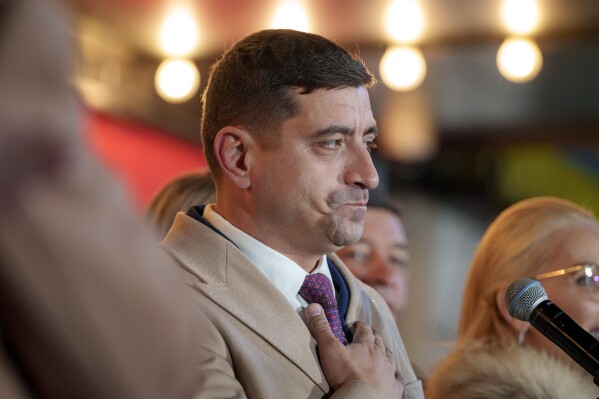George Simion, the Alliance for the Unity of Romanians (AUR) candidate for president reacts after polls closed during the country's presidential elections, in Bucharest, Romania, Sunday, Nov. 24, 2024. (AP Photo/Andreea Alexandru)