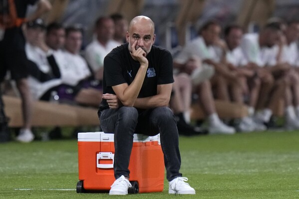 Manchester City manager Pep Guardiola looks on during a friendly soccer match against Bayern at the National Stadium in Tokyo, Japan, Wednesday, July 26, 2023.(AP Photo/Shuji Kajiyama)