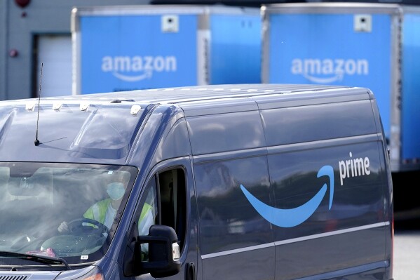 FILE - The Amazon Prime logo appears on the side of a delivery van as it departs an Amazon Warehouse location, Oct. 1, 2020, in Dedham, Mass. Amazon announced at a conference for delivery firms on Tuesday, Sept. 12, 2023, that it will invest $440 million over the next year to increase pay rates for drivers. It did not disclose how much the bump will be, but said it expects U.S. drivers to earn an average of $20.50 per hour. (AP Photo/Steven Senne, File)