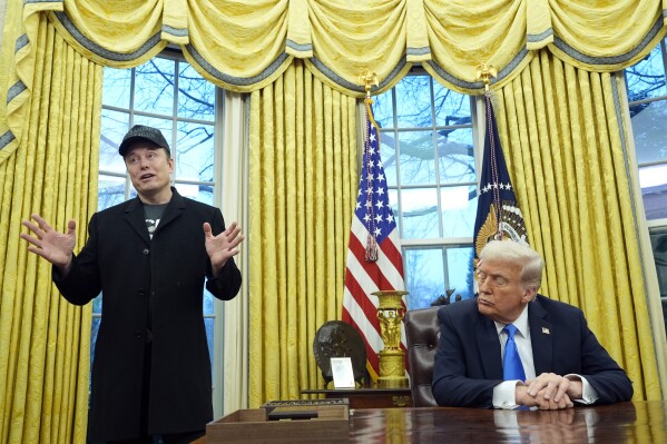 President Donald Trump listens as Elon Musk speaks in the Oval Office at the White House, Feb. 11, 2025, in Washington. (AP Photo/Alex Brandon, File)