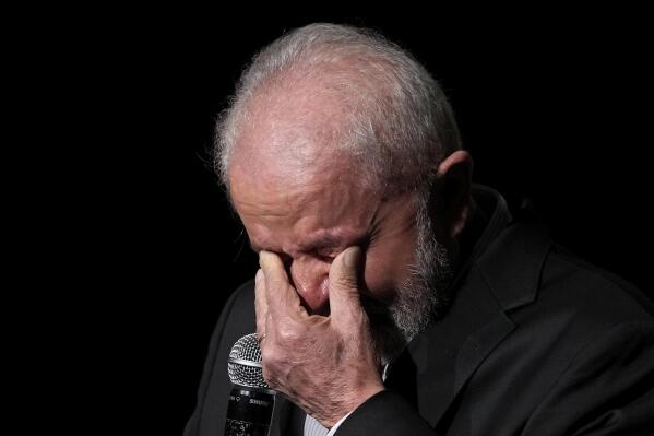 Brazilian President-elect Luiz Inacio Lula da Silva wipes tears as he speaks about his government's proposals for the poor during a meeting with lawmakers and community leaders at his transitional government headquarters in Brasilia, Brazil, Thursday, Nov. 10, 2022. Da Silva will be sworn-in on Jan. 1. (AP Photo/Eraldo Peres)