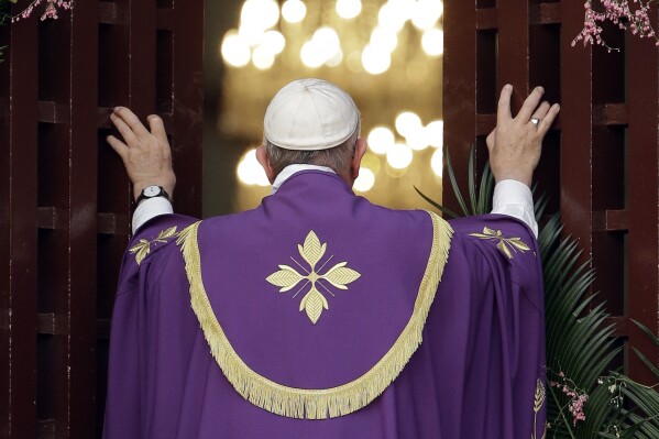Pope Francis opens the holy door of the Bangui cathedral, Central African Republic, Sunday, Nov. 29, 2015. Pope Francis is in Africa for a six-day visit that is taking him to Kenya, Uganda and the Central African Republic. (AP Photo/Andrew Medichini)