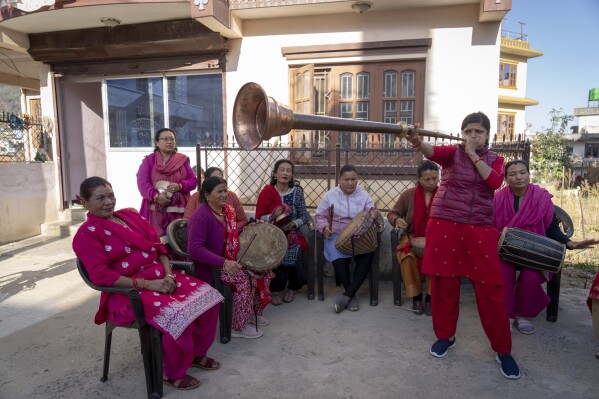 Durga Gautam, 30, plays a Karnal, a traditional musical instrument, during rehearsals of her Naumati Baja, or nine traditional instruments, band in Kathmandu, Nepal, Tuesday, March 5, 2024. (AP Photo/Niranjan Shrestha)