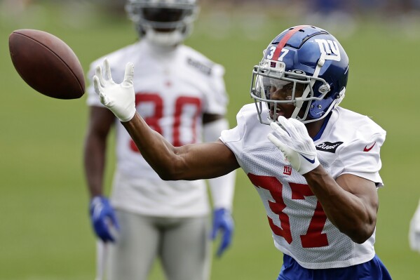 FILE - New York Giants cornerback Tre Hawkins III drops the ball during the NFL football team's practice on June 14, 2023, in East Rutherford, N.J. Hawkins of Old Dominion has been somewhat of surprise for the New York Giants. A little more than a week into camp, he has been getting his share of reps with the first-team defense and the 22-year-old has held his own. (AP Photo/Adam Hunger, File)