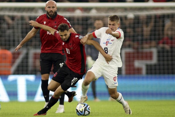 FILE - Czech Republic's Michal Sadilek, right, challenges for the ball with Albania's Nedim Bajrami during the Euro 2024 group E qualifying soccer match between Albania and Czech Republic at Air Albania stadium in Tirana, Albania, Thursday, Oct. 12, 2023. Czech Republic midfielder Sadílek will miss the European Championship after sustaining a leg injury while riding a bicycle, the Czech team said on Sunday, June 9, 2024. (AP Photo/Franc Zhurda, File)