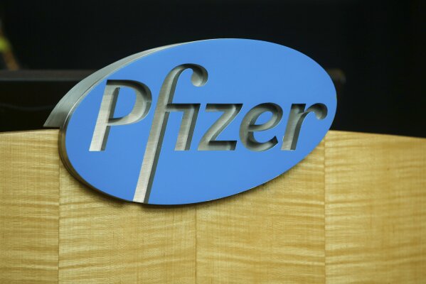 FILE - In this file photo dated Wednesday, July 22, 2020, a Pfizer sign is seen on a podium at the Pfizer Research & Development Laboratories, in Groton, USA.  The U.K. health authorities rolled out a national mass vaccination program Tuesday Dec. 8, 2020, using the Pfizer-BioNTech COVID-19 vaccine.  U.K. regulators said Wednesday Dec. 9, 2020, that people who have a “significant history’’ of allergic reactions shouldn’t receive the new Pfizer/BioNTech vaccine while they investigate two adverse reactions that occurred on the first day of the country’s mass vaccination program. (AP Photo/Stew Milne)