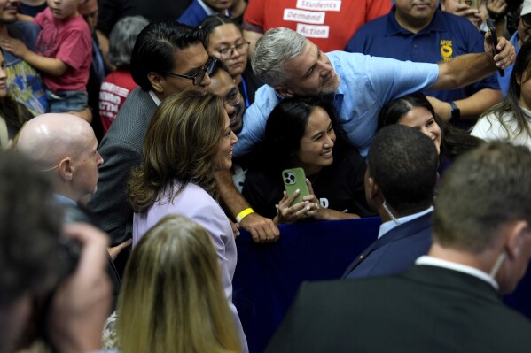 Democratic presidential nominee Vice President Kamala Harris takes a selfie with supporters at a campaign rally, Saturday, Aug. 10, 2024, in Las Vegas. (AP Photo/Julia Nikhinson)