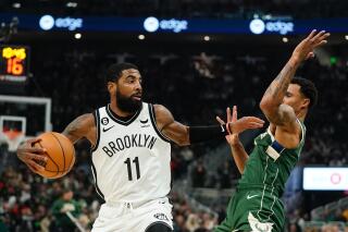 Brooklyn Nets' Kyrie Irving tries to get past Milwaukee Bucks' George Hill during the first half of an NBA basketball game Wednesday, Oct. 26, 2022, in Milwaukee. (AP Photo/Morry Gash)