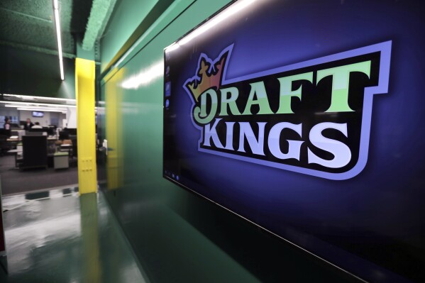 FILE - The DraftKings logo is displayed at the sports betting company headquarters, May 2, 2019, in Boston. DraftKings apologized Monday, Sept. 11, 2023, after using the Sept. 11, 2001, terror attacks to entice people to bet on baseball and football games on the anniversary of the tragedy that killed nearly 3,000 people. (AP Photo/Charles Krupa, File)