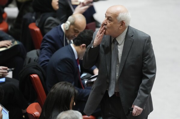 Riyad Mansour, Palestinian Ambassador to the United Nations, blows a kiss to someone before the start of Security Council meeting at United Nations headquarters, Tuesday, Feb. 20, 2024. (AP Photo/Seth Wenig)