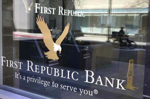File - First Republic Bank signs and logos are attached to a window at a branch location, Wednesday, April 26, 2023, in Boston. Regulators seized troubled First Republic Bank early Monday and sold all of its deposits and most of its assets to JPMorgan Chase Bank in a bid to head off further banking turmoil in the U.S. (AP Photo/Steven Senne, File)