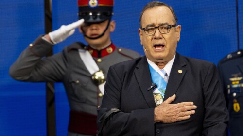 FILE - Guatemalan President Alejandro Giammattei sings the national anthem before giving his third annual address to the nation at the National Palace in Guatemala City, Jan. 14, 2023. Giammattei released a statement on Monday, July 10 saying he will respect the four-year term for which he was elected, which ends on Jan. 14, 2024, until the results of the June 25 general election are yet to be made official. (AP Photo/Moises Castillo, File)