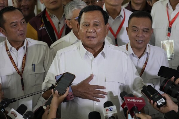 Indonesian presidential hopeful and Defense Minister Prabowo Subianto, center, gestures during a press conference in Jakarta, Indonesia, Monday, Oct. 23, 2023. The world's third-largest democracy is holding its legislative and presidential elections on Feb. 14, 2024. (AP Photo/Achmad Ibrahim)