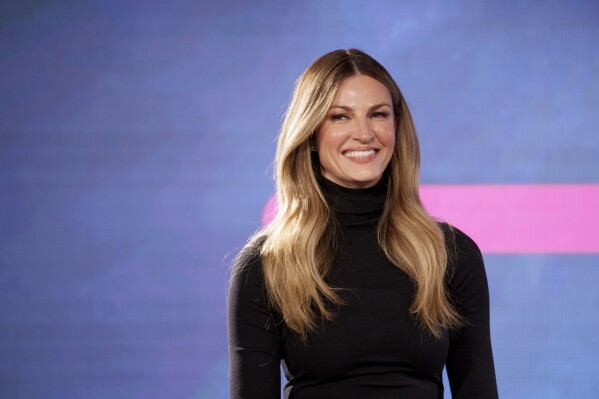 Erin Andrews smiles at a news conference announcing Tiger Woods' new clothing line, called Sun Day Red, ahead of the Genesis Open golf tournament, Monday, Feb. 12, 2024, in the Pacific Palisades area of Los Angeles. (AP Photo/Eric Thayer)