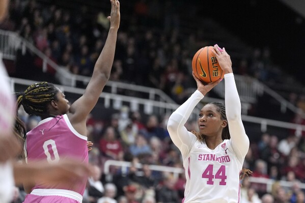 Stanford forward Kiki Iriafen (44) shoots over California forward Ugonne (Michelle) Onyiah (0) during the second half of an NCAA college basketball game Friday, Feb. 16, 2024, in Stanford, Calif. (AP Photo/Tony Avelar)