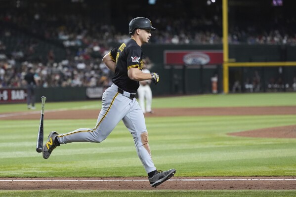 Pittsburgh Pirates' Bryan Reynolds flips his bat as he starts rounding the bases after hitting a three-run home run against the Arizona Diamondbacks during the eighth inning of a baseball game Tuesday, May 27, 2025, in Phoenix. (AP Photo/Ross D. Franklin)