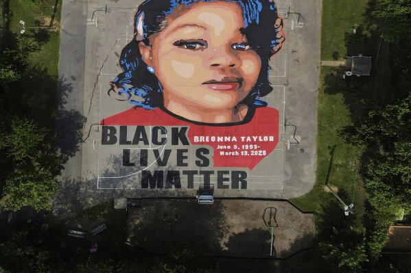 A ground mural depicting a portrait of Breonna Taylor is seen at Chambers Park, Monday, July 6, 2020, in Annapolis, Md. The mural honors Taylor, a 26-year old Black woman who was fatally shot by police in her Louisville, Ky., apartment. The artwork was a team effort by the Banneker-Douglass Museum, the Maryland Commission on African American History and Culture, and Future History Now, a youth organization that focuses on mural projects. (AP Photo/Julio Cortez)
