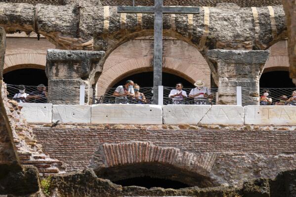 Visitors admire the newly restored lower level of the Colosseum during an event for the media, in Rome, Friday, June 25, 2021. After 2-and-1/2 years of work to shore up the Colosseum’s underground passages, tourists will be able to go down and wander through part of what what had been the ancient arena’s “backstage.” (AP Photo/Andrew Medichini)