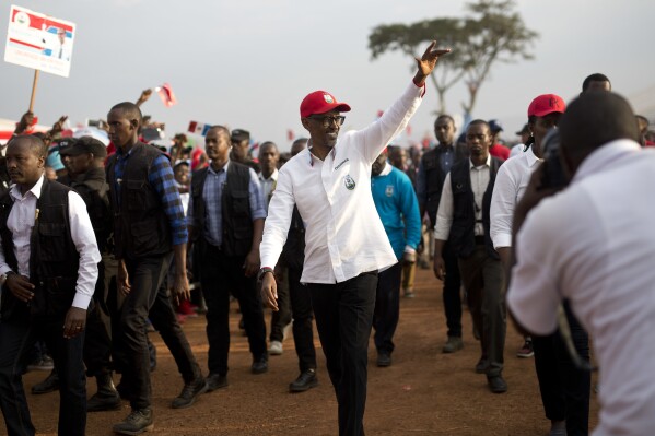 FILE - Rwanda's President Paul Kagame wave as he leaves an election campaign rally on the hills overlooking Kigali, Rwanda, on Aug. 2, 2017. Rwandans are voting Monday in an election that will almost certainly extend the long rule of Kagame, who is running virtually unopposed after three decades in power in the eastern African nation. (ĢӰԺ Photo/Jerome Delay, File)