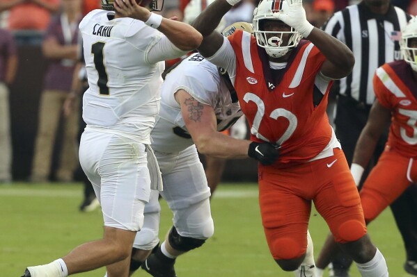 Purdue quarterback Hudson Card (1) is pressured by Virginia Tech defender Mario Kendricks (22) during the second quarter of an NCAA college football game in Blacksburg, Va., Saturday, Sept. 9 2023. (Matt Gentry/The Roanoke Times via AP)