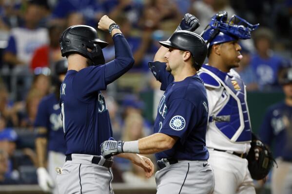 Seattle Mariners' Jesse Winker, left, congratulates Cal Raleigh at home plate after Raleigh's two-run home run against the Kansas City Royals during the sixth inning of a baseball game in Kansas City, Mo., Saturday, Sept. 24, 2022. (AP Photo/Colin E. Braley)