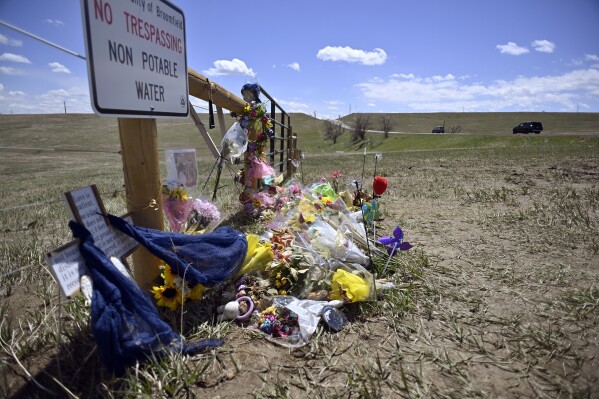 A roadside memorial for Alexa Bartell, age 20, who was killed by a rock thrown at her vehicle on April 19, 2023 stands on April 28, in Broomfield, Colo. Three teenagers charged with her murder are set to appear in court Wednesday, Oct. 18, for an evidentiary hearing to determine if their case should go to trial. (Eric Lutzens/The Denver Post via AP)