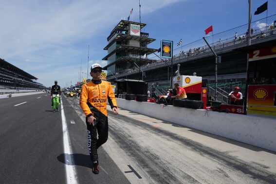 Pato O'Ward, of Mexico, walk down pit lane during a practice session for the Indianapolis 500 auto race at Indianapolis Motor Speedway, Monday, May 20, 2024, in Indianapolis. (AP Photo/Darron Cummings)