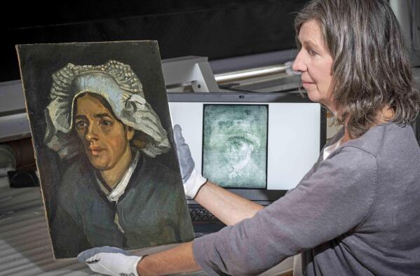 Senior Conservator Lesley Stevenson views Head of a Peasant Woman alongside an x ray image of the hidden Van Gogh self portrait. A previously unknown self-portrait of Vincent Van Gogh has been discovered behind another of the artist’s paintings. The National Galleries of Scotland said Thursday it was discovered on the back of Van Gogh’s “Head of a Peasant Woman” when experts took an X-Ray of the canvas ahead of an upcoming exhibition. (Neil Hanna via AP)