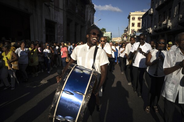 Musicians perform during a procession honoring Cuba's patron saint, the Virgin of Charity of Cobre, on her feast day in Havana, Friday, Sept. 8, 2023. (AP Photo/Ramon Espinosa)